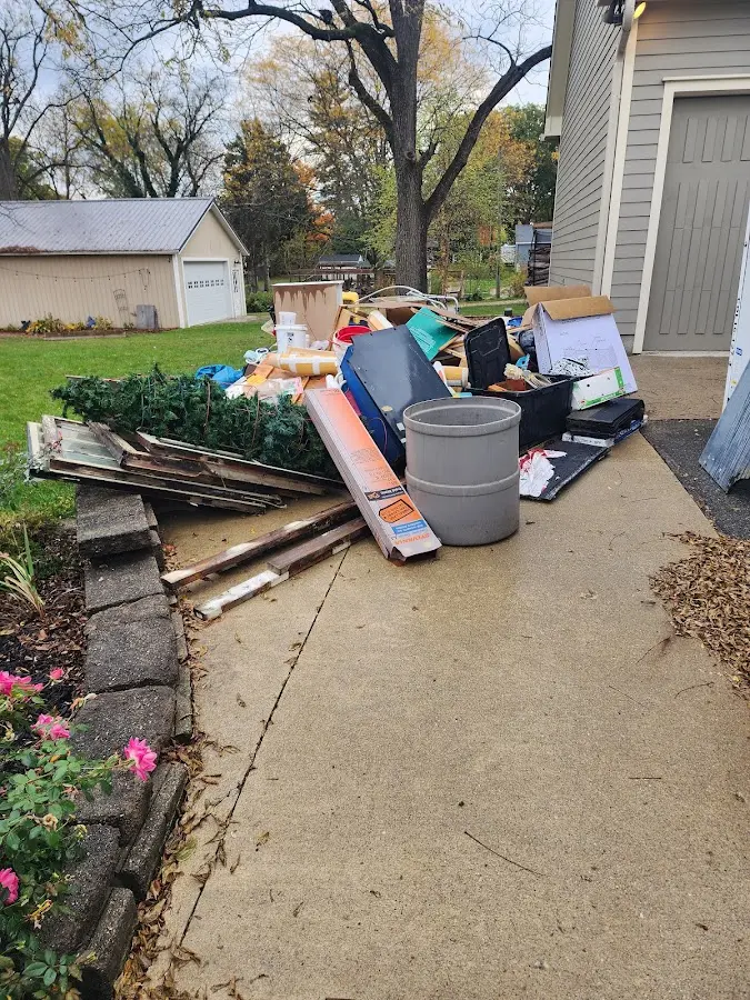 Dumpster being loaded with debris for Roofing Dumpster Rental in Northfield